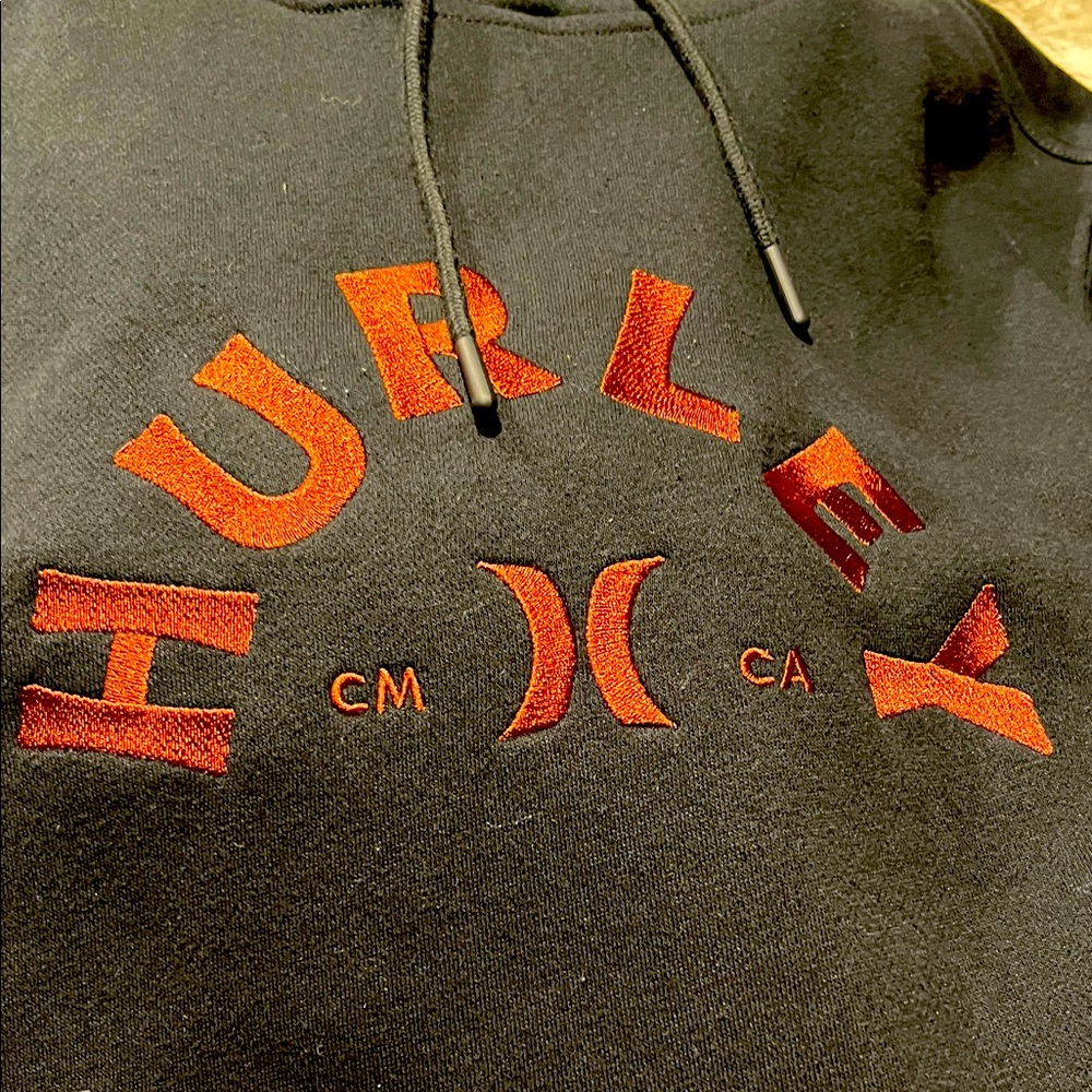 Hurley Black hoodie  with bronze accents size small , brand new never worn.